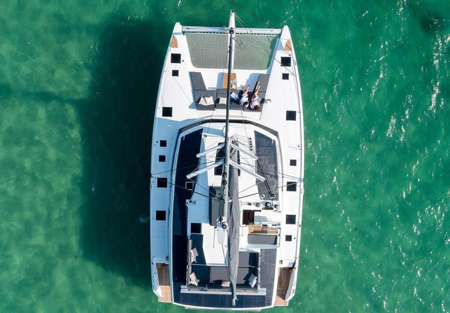 Mykonos: Catamaran Cruise with 3-Course Meal and Transfers - Your water hour at Rhenia: swim, snorkel, kayak, and SUP