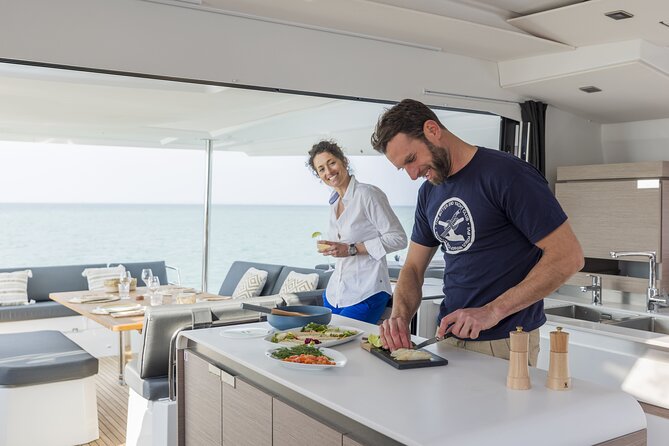 Mykonos: Luxury Catamaran Cruise with Meal, Drinks & Transport - Water time: snorkeling gear, SUP, and a practical approach to playing