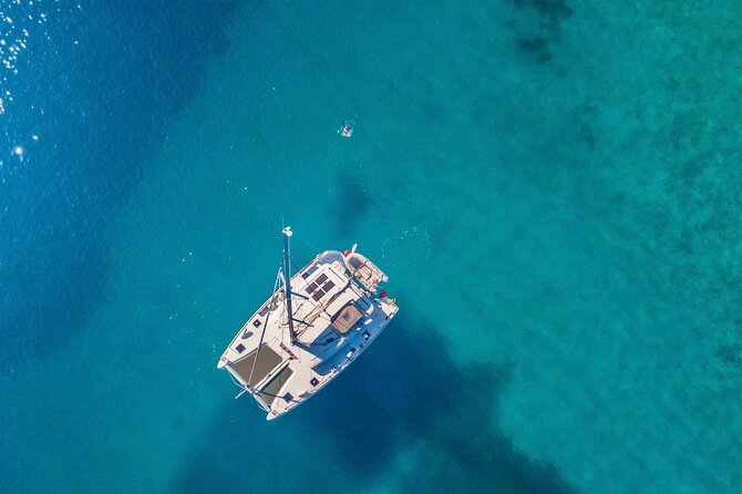 Mykonos: Private Catamaran Cruise—Hotel Pickup, BBQ & Drinks - Delos in about an hour: ruins, context, and sea views